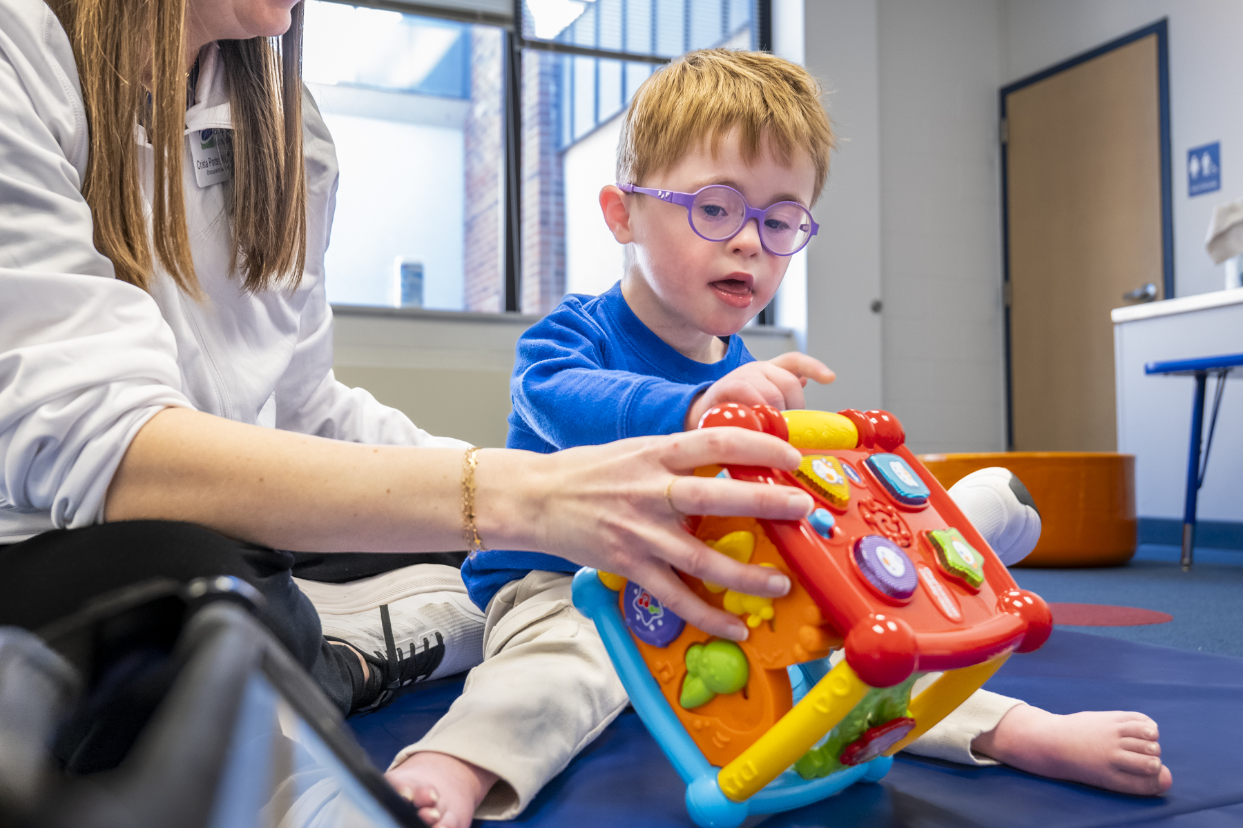 Child with Down syndrome and therapist interacting